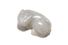 A WHITE JADE CARVING OF A RECUMBENT ANIMAL