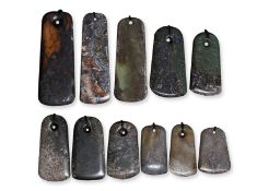A GROUP OF ELEVEN ARCHAISTIC JADE AXE HEADS OR PENDANTS