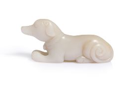 A PALE CELADON-WHITE JADE CARVING OF A DOG