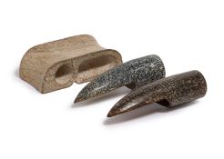 TWO CARVED JADE NAIL GUARDS AND AN ARCHAISTIC JADE SWORD FITTING
