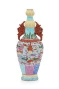 A FAMILLE ROSE 'BUDDHIST LIONS' RELIEF MOULDED VASE
