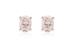 A PAIR OF OVAL DIAMOND STUD EARRINGS