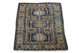 AN ANTIQUE CAUCASIAN WOOL RUG (165 X 125CM)
