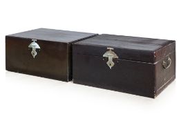 A PAIR OF BLACK LACQUERED LEATHER TRUNKS