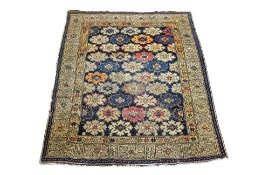 AN ANTIQUE TRIBAL WOOL RUG WITH ALLOVER FLORAL DESIGN (150 X 116CM)