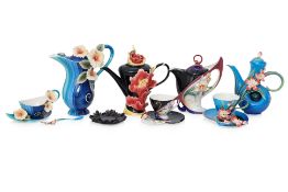 A GROUP OF FRANZ PORCELAIN TEAPOTS, CUPS AND SAUCERS (12)