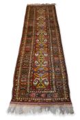 AN ANTIQUE PERSIAN WOOL RUNNER (330 X 88CM)