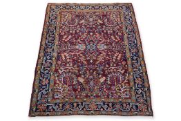 A SMALL FLORAL WOOL RUG (150 X 108CM)