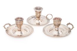 THREE EGYPTIAN SILVER CHAMBERSTICKS
