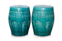 A PAIR OF GREEN GLAZED BARREL FORM POTTERY STOOLS