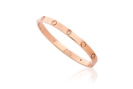 A GOLD AND DIAMOND SET BANGLE