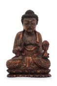 A CARVED GILT WOOD FIGURE OF A SEATED BUDDHA