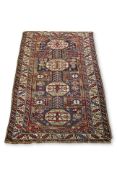 A CAUCASIAN TRIBAL GEOMETRIC WOOL RUG (180 X 105CM)