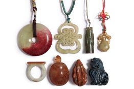 A GROUP OF EIGHT CHINESE HARDSTONE AND JADE PENDANTS
