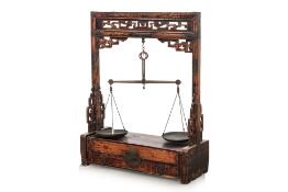 AN APOTHECARY STAND AND SCALES