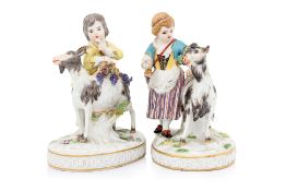 A PAIR OF MEISSEN FIGURES OF BOYS AND GIRLS WITH GOATS