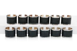 TWO SETS OF SIX MANOP RACHOTE SILVER PLATE AND LEATHER NAPKIN RINGS