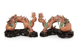 A PAIR OF PORCELAIN DRAGON FIGURES ON STANDS