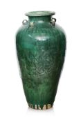 A LARGE GREEN GLAZED POTTERY MARTABAN JAR
