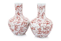 A PAIR OF CHINESE IRON RED DRAGON PORCELAIN BOTTLE VASES