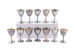 A SET OF TWELVE SMALL ORIENTAL SILVER GOBLETS