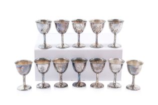 A SET OF TWELVE SMALL ORIENTAL SILVER GOBLETS