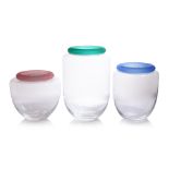 A GROUP OF THREE IVV GLASS JARS WITH COLOURED LIDS