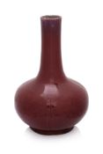 AN OX-BLOOD GLAZED PORCELAIN BOTTLE VASE