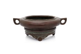 A BRONZE CENSER WITH TWIN LOOP HANDLES
