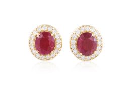A PAIR OF RUBY AND DIAMOND 'HALO' STUD EARRINGS