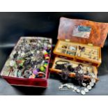 A tin and jewellery case of costume jewellery