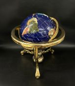 A table top gemstone world globe, raised on brass tripod stand, 30cm h
