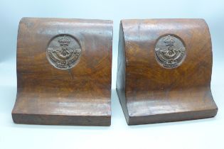 A pair of wooden book ends repr. Frontier Force rifles