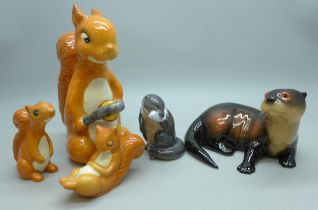 Three Beswick squirrel figures, together with a Royal Copenhagen otter figure and other example