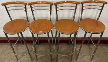 A set of four beech and chrome bar stools