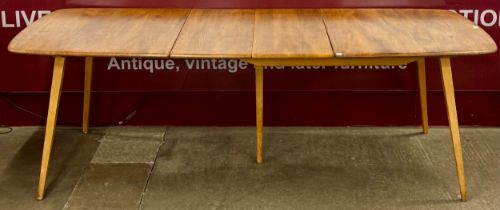 An Ercol Blonde elm and beech Grand Windsor extending dining table