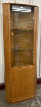 An Ercol Blonde ash model 3856 Windsor corner cabinet