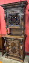 A 19th Century Flemish extensively carved oak and stained glass side cabinet