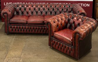 A Regency style oxblood red leather Chesterfield settee and club chair