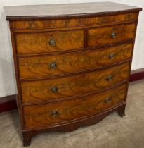 A George IV flame figured mahogany bowfront chest of drawers