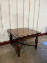An early 20th Century oak draw-leaf table