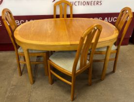 A Nathan teak oval extending dining table and four chairs