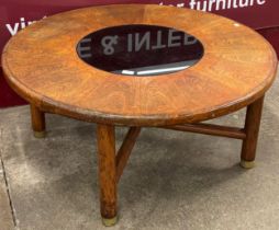 A G-Plan teak and smoked glass topped circular coffee table