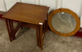 A teak nest of tables and a simulated teak framed mirror