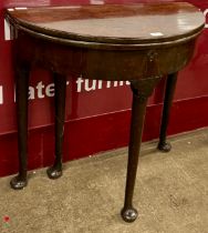 A George I Cuban mahogany demi-lune fold-over tea table