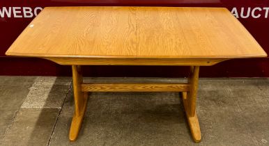 An Ercol Blonde ash model 1193 Windsor rectangular extending dining table