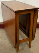 A teak drop-leaf table