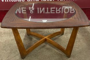 A teak and glass topped coffee table