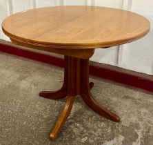 A Nathan teak circular extending dining table