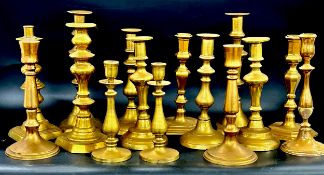 A collection of brass candlesticks